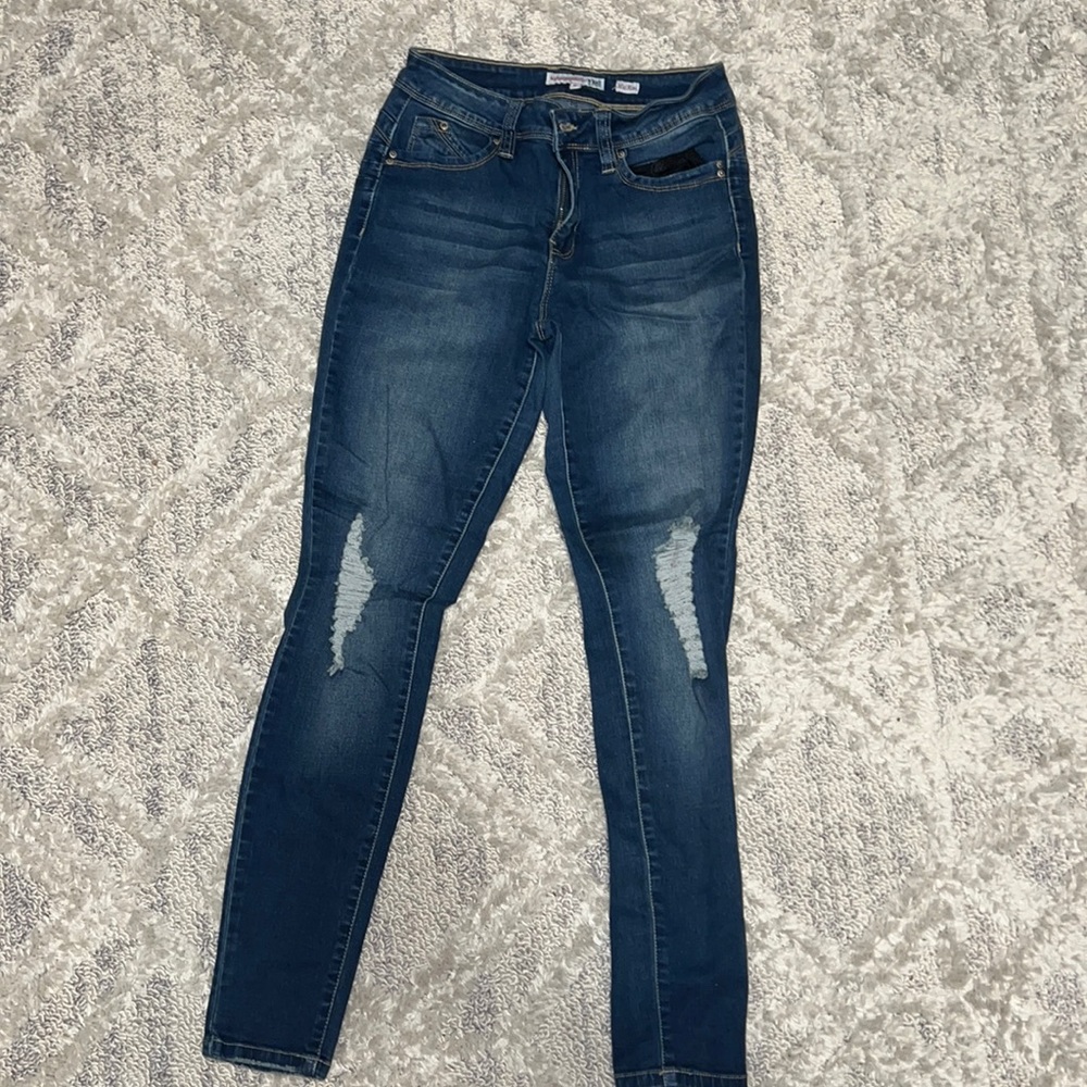 Dark jeans, distressed on the knees